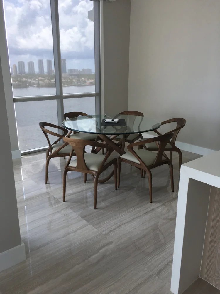 High-rise balcony marble flooring with waterway views — Miami condo renovation